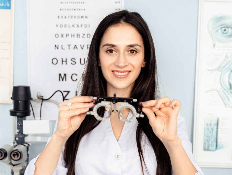 A woman conducting an eye exam.